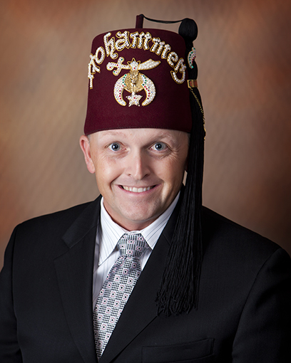 Portrait of Game Chairman Eric Tjarks wearing a Mohammed Shriners fez